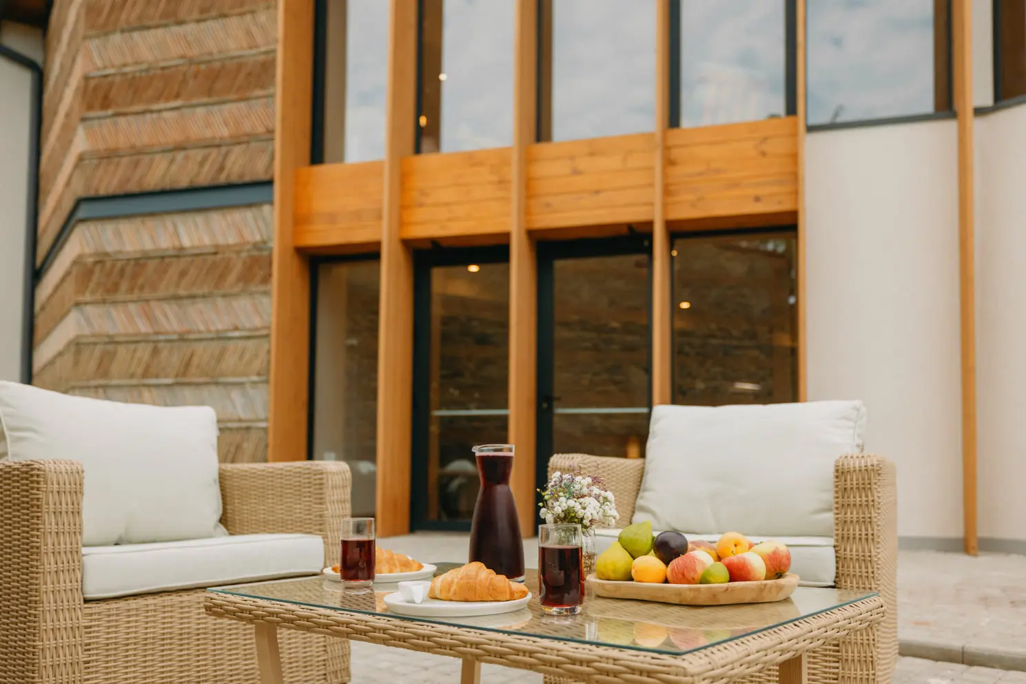 Wicker armchairs, fruit and a jug of wine on the terrace