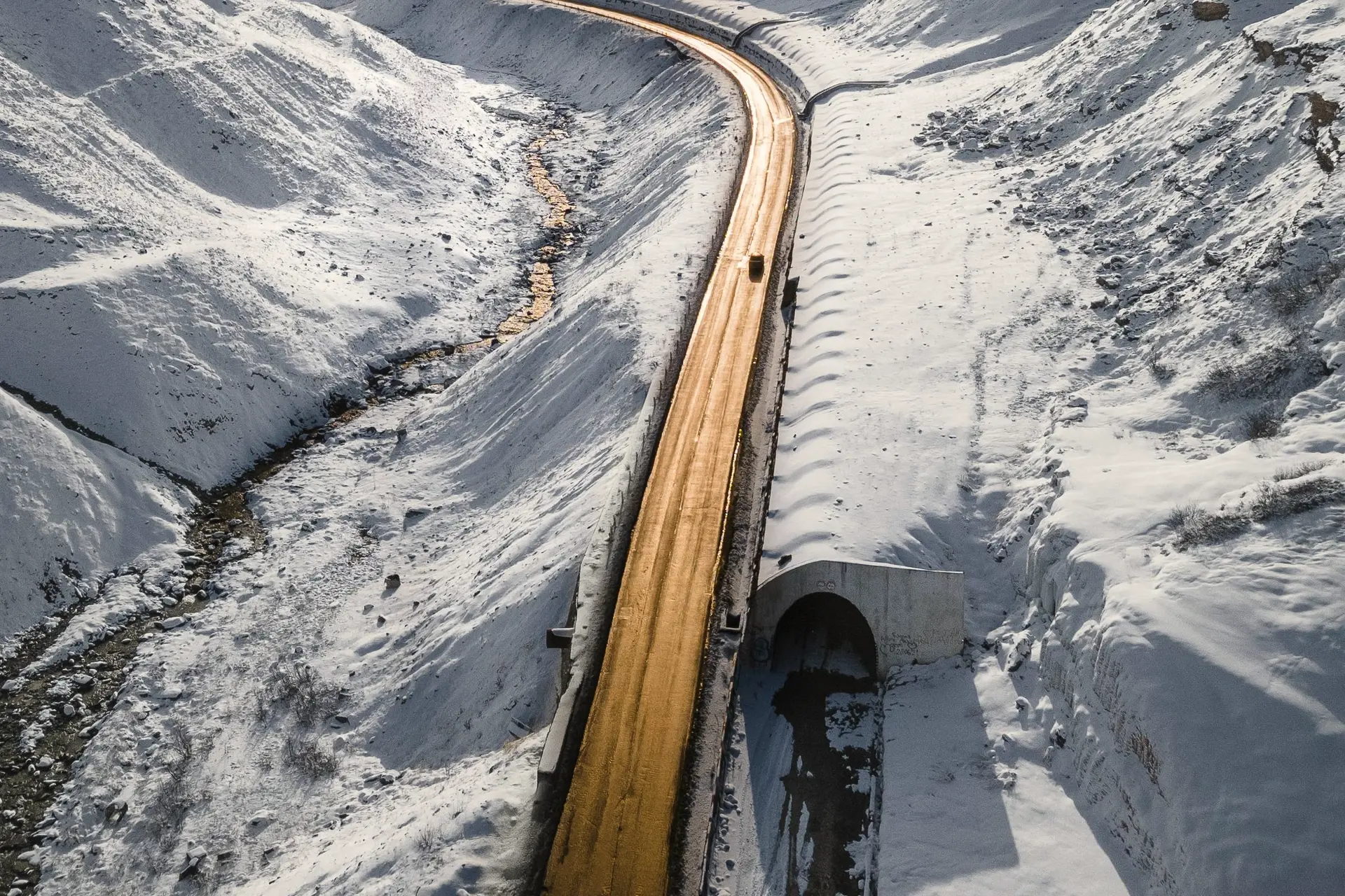 The Georgian Military Road beyond Gudauri in winter, with an avalanche gallery and snow on every slope