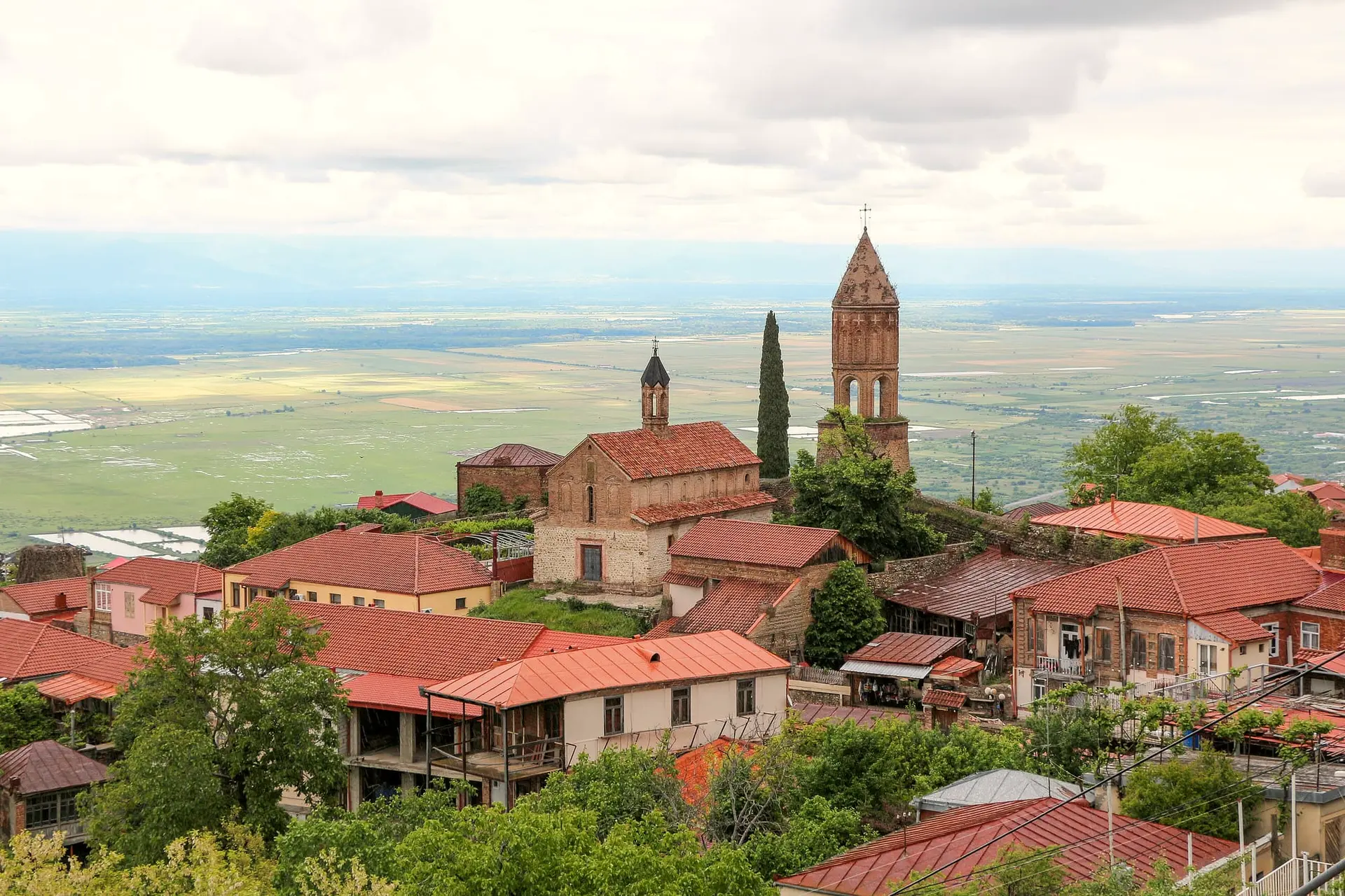 Red roofs of Sighnaghi and a church bell tower above the Alazani Valley